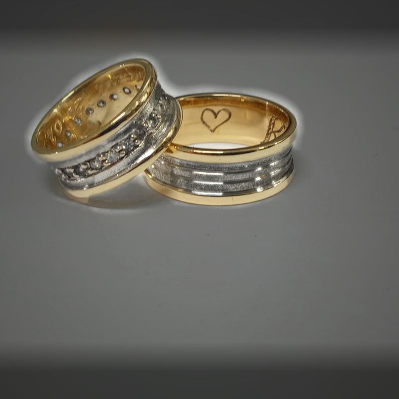 Alianças personalizadas em ouro amarelo e branco com fileira de pedras e coração gravado por dentro