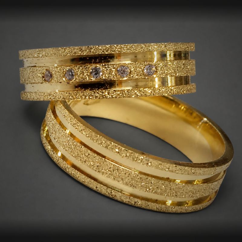Alianças personalizadas em ouro com faixas diamantadas e cinco pedras na aliança feminina